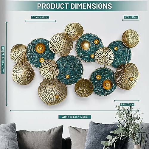 Abstract metal wall art with circular designs in teal and gold colors, shown with dimensions.