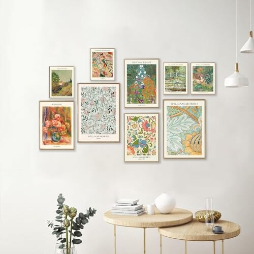 A collection of framed art prints arranged on a wall above a modern table.