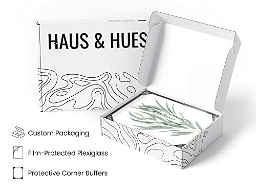 Open packaging box with botanical artwork inside.