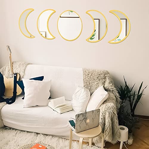 Boho living room with moon phase mirrors and cozy sofa.