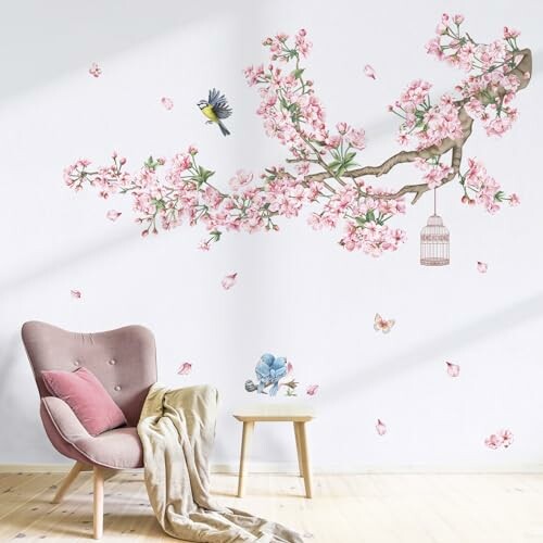 Room with cherry blossom wall art, chair, and birdcage.