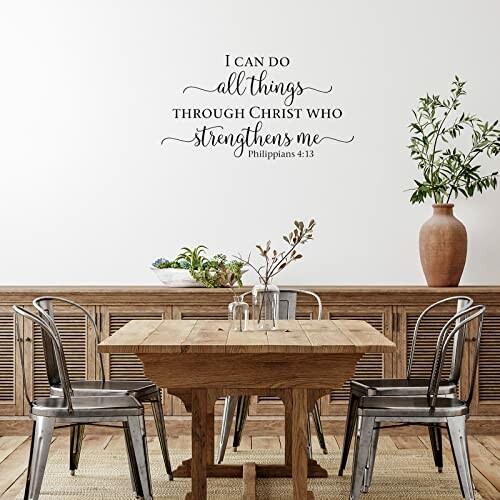 Dining room with wooden table, metal chairs, and wall quote from Philippians 4:13.