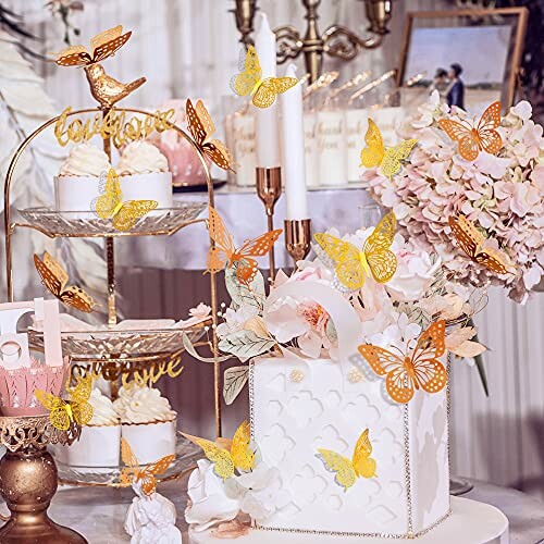 Elegant wedding cake decor with gold butterflies and floral arrangements.