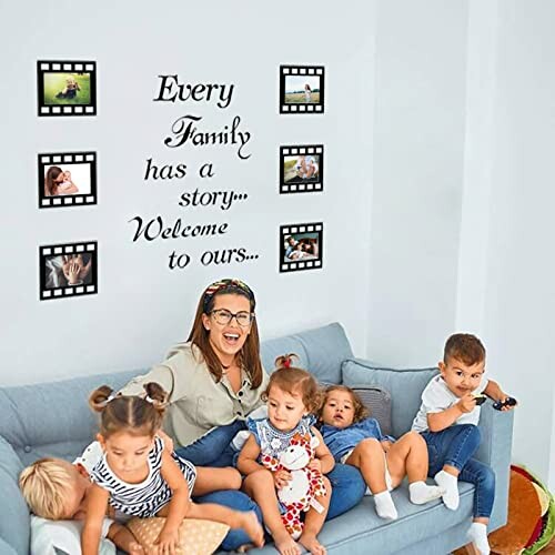 Woman sitting on a couch with five children, family photo wall decor in the background.