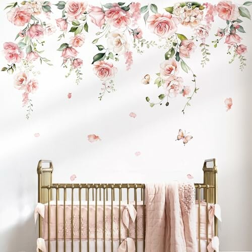 A beautiful gold crib with pink floral wall decals and butterflies.