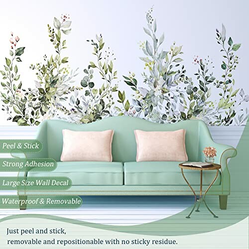 Living room with floral wall decal and green sofa.