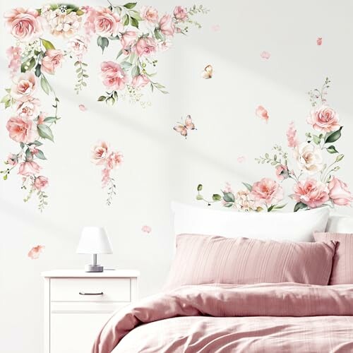 A beautifully decorated bedroom with floral wall decals and pink bedding.