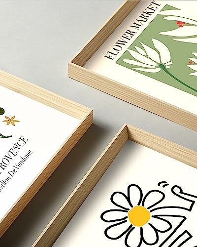 Framed flower illustrations on a table.