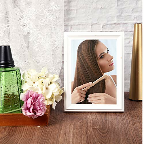 Framed photo of woman combing hair with decorative items.