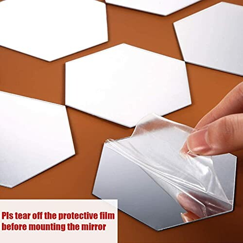 Hand peeling protective film from hexagon mirror tiles.