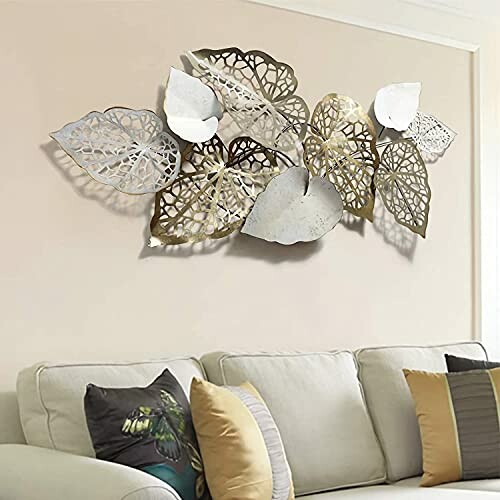 Decorative metal leaf wall art above sofa