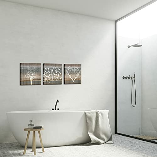 Minimalist bathroom with bathtub and wall art.