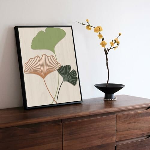 Minimalist floral artwork on wooden dresser with yellow flower vase.