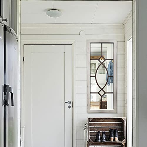 Hallway with decorative mirror and shoe rack.