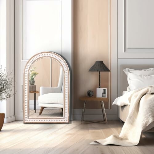 Stylish bedroom with a large arched mirror and cozy furnishings