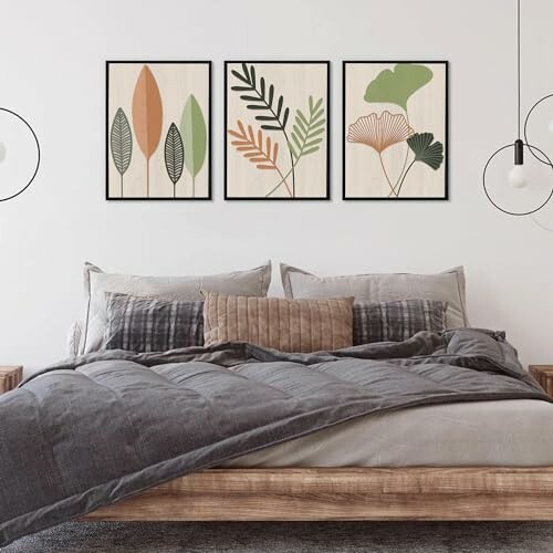 Modern bedroom with wooden bed and leaf-themed wall art.