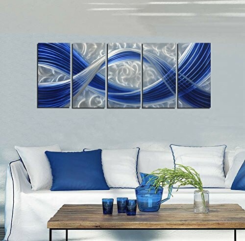 Living room with blue abstract wall art and white sofa.