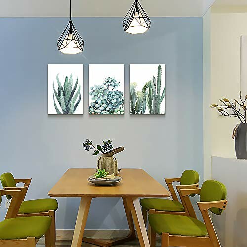 Modern dining area with wooden table, green chairs, and plant artwork.