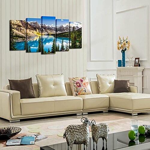 Modern living room with cream sofa and mountain landscape art.