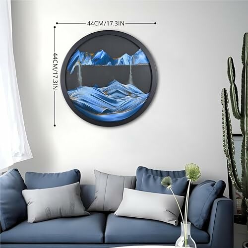 Modern living room with a round mountain-themed wall art and a blue sofa.