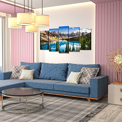 Modern living room with blue sofa, wall art, and pendant lights.