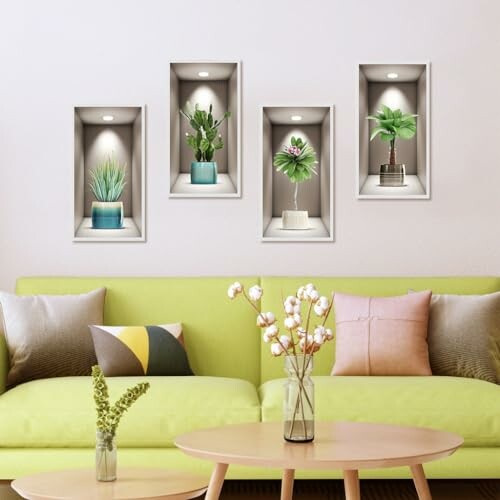 Living room with wall decor featuring potted plants and a green sofa.