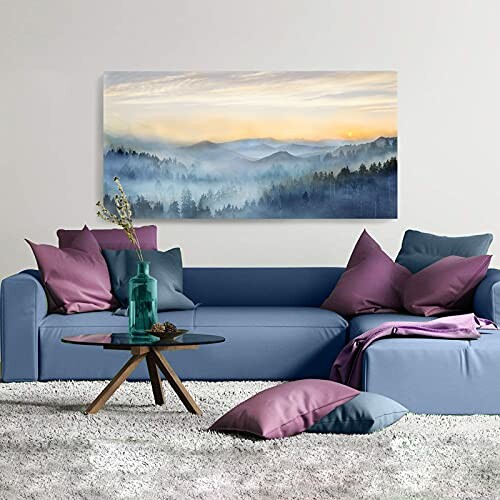 Modern living room with blue sofa, colorful pillows, and landscape artwork on wall.