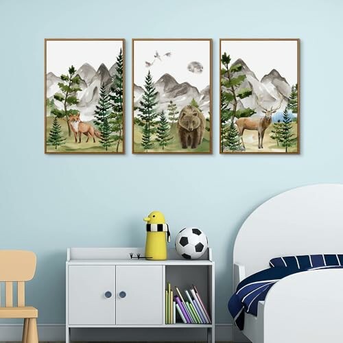 Three-panel wall art of wildlife and mountains in a child's room.