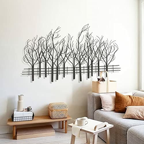 Wall art of silhouetted trees above a couch in a living room.