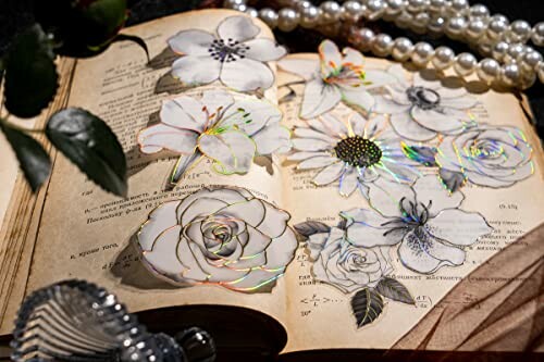 Vintage book with pressed flowers and pearl necklace.