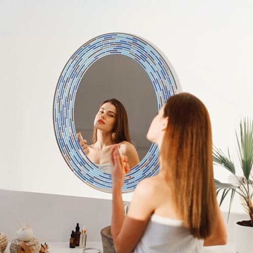 Woman applying lipstick in front of a decorative round mirror.